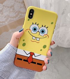 a person holding up a phone case with a cartoon character on it