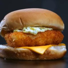 a fried chicken sandwich with cheese and mayonnaise