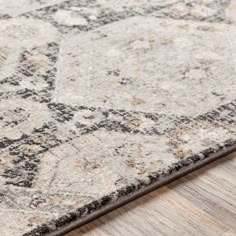 an area rug with grey and white colors