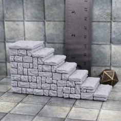 a set of stairs made out of white bricks with a gold dice on the bottom