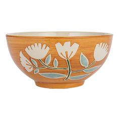 a wooden bowl with flowers painted on the side and green leaves in the middle, sitting on a white background