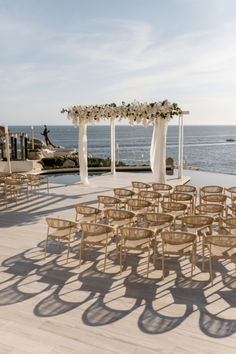 an outdoor wedding setup with chairs and flowers