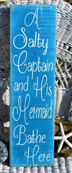 a salty captain and his mermaid bathe me here sign on a wicker chair