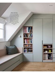 an attic bedroom with built in bookshelves and storage