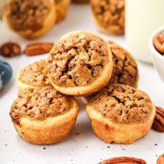 several pecan pies are stacked on top of each other next to a glass of milk