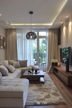 a living room filled with furniture and a flat screen tv