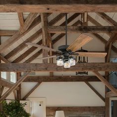 a living room with wooden beams and a ceiling fan