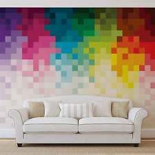 a white couch sitting in front of a rainbow colored wall mural on the side of a room