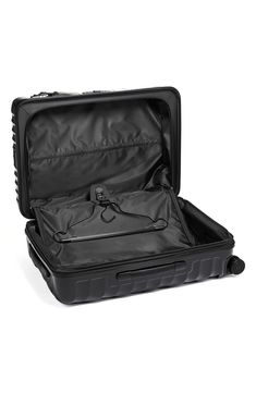 an open black suitcase with wheels and handle on the inside is seen against a white background