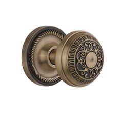 an antique brass door knob with ornate design on it's face and the handle is shown