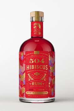 a bottle of red wine with gold trimmings on the top and bottom, in front of a white background