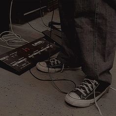 a person standing on the ground with their feet up and wires in front of them