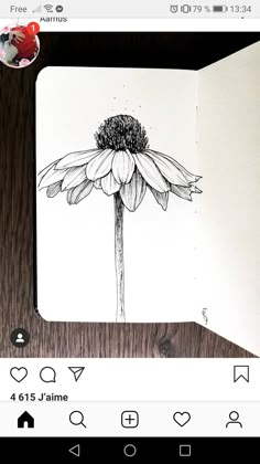 an open notebook with a drawing of a flower on it