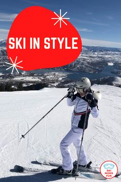 a man riding skis down the side of a snow covered slope under a red sign