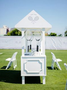 two tennis racquets sitting on top of a white cabinet in the grass