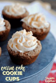 several cupcakes with frosting on top sitting on a blue plate next to a red and white napkin