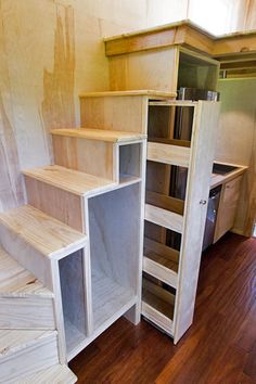 the stairs are made out of plywood and have been built into the wall for storage