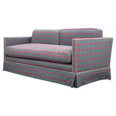 a blue and red plaid couch sitting on top of a white floor