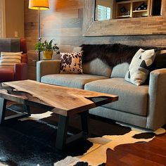 a living room filled with furniture and a cowhide rug