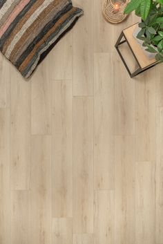 an overhead view of a living room with wood flooring and decorative items on the table