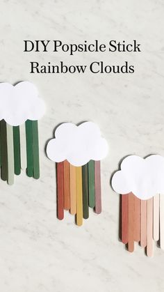 three popsicle rainbows with clouds on them