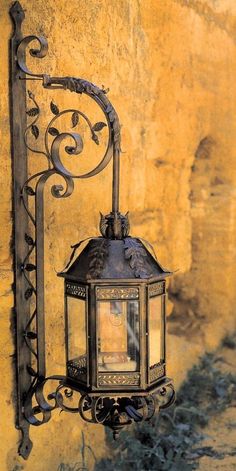 an old fashioned lantern hanging on the side of a building