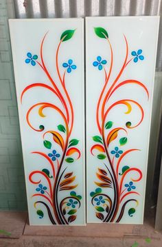 two decorative glass doors with flowers and leaves painted on them