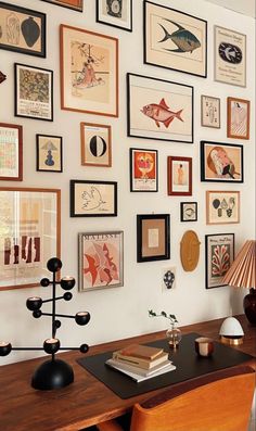 there are many framed pictures on the wall