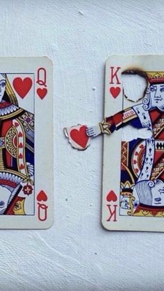 two playing cards that have been made to look like king and queen of spades