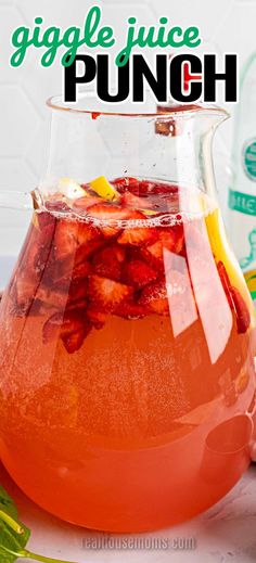 a pitcher filled with liquid sitting on top of a table