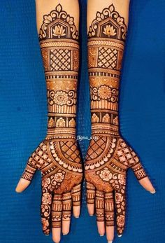 two hands with henna tattoos on them, one is showing the intricate design and the other has ornate designs