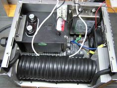 the inside of an electronic device with wires and other equipment in it's compartment