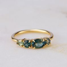 three stone ring sitting on top of a table