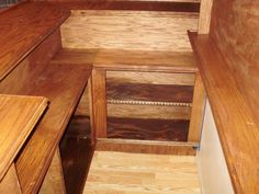 the inside of a wooden bench in a room