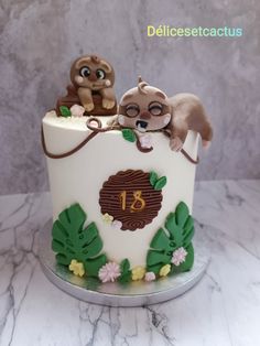 a birthday cake with two monkeys on top