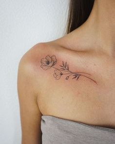 a woman with a flower tattoo on her shoulder