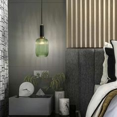 a bedroom with a bed, nightstand and green glass light hanging over the headboard