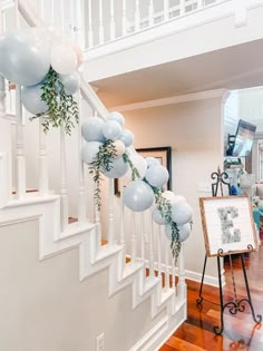 balloons and greenery are hanging from the banister