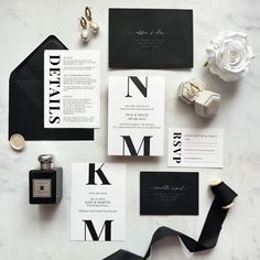 black and white wedding stationery with monogrammed letters, calligraphy, and ribbon