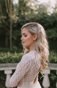 a woman wearing a wedding dress and hair comb