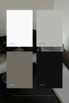 some white and grey paint colors in different shades on a table with a black chair