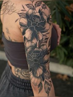 a woman with a flower tattoo on her arm