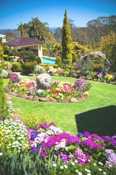 the garden is full of colorful flowers and trees