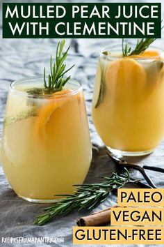 two glasses filled with orange juice and garnished with rosemary on the rims