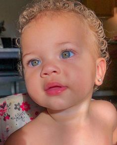 a close up of a child with blue eyes