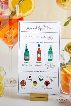 a cocktail bar sign sitting on top of a table next to glasses filled with drinks