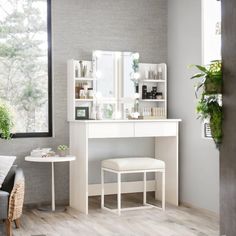 a white dressing table with stool and mirror in a living room next to a window