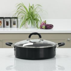 a black pot sitting on top of a white counter