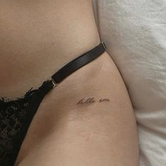 a woman's stomach with the word love tattooed on her left side ribcage