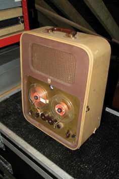 an old radio sitting on top of a table